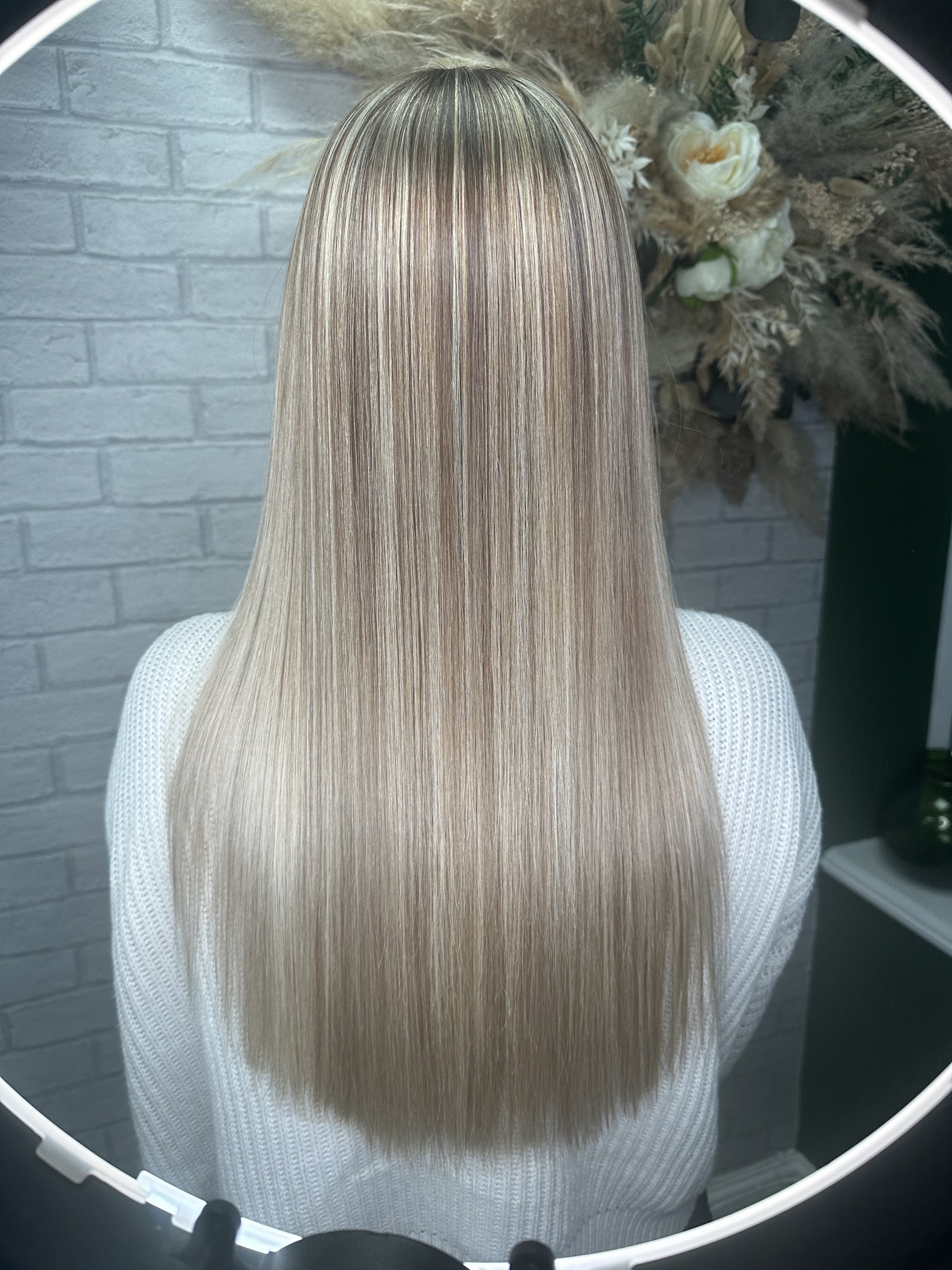 Long, straight blended blonde in the studio ring light