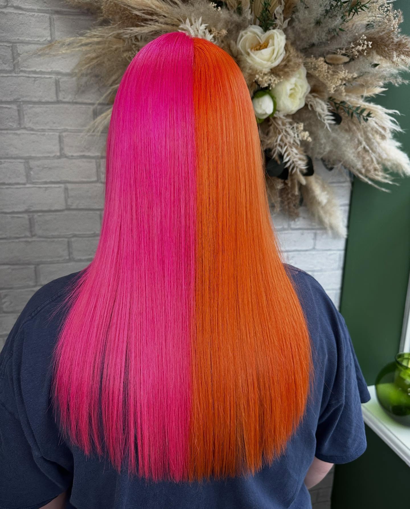 A pink and orange split colour on long straight hair