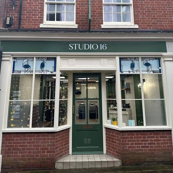 The Studio 16 shopfront on School Lane, with its green fascia and door